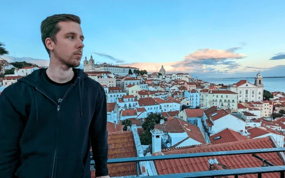 Cristian Fry looking out over a city at sunset